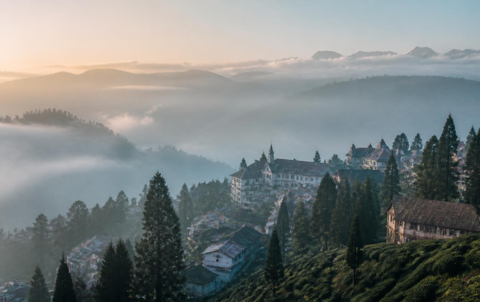 Misty hillside view of Darjeeling at dawn